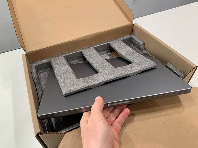 Laptop box fully opened with laptop being loaded inside